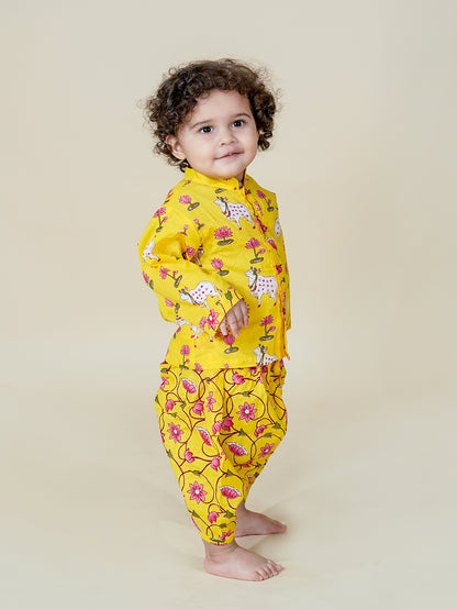 Child wearing a yellow floral onesie on a beige background