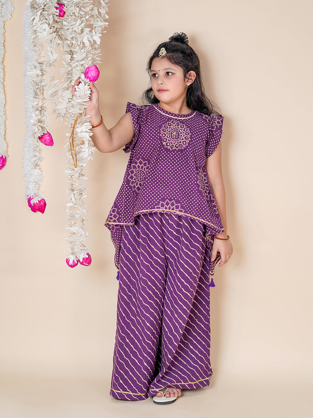  Girl Child in a purple traditional outfit with decorative elements on a beige background