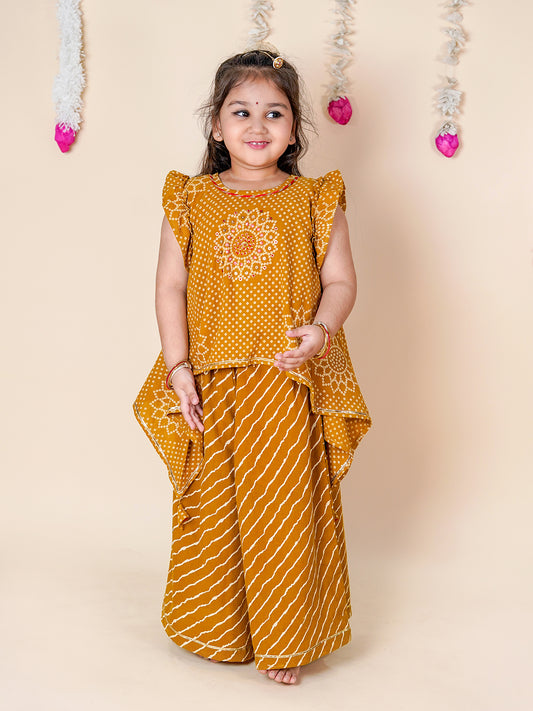Young girl wearing a mustard yellow traditional outfit with a floral design on a beige background