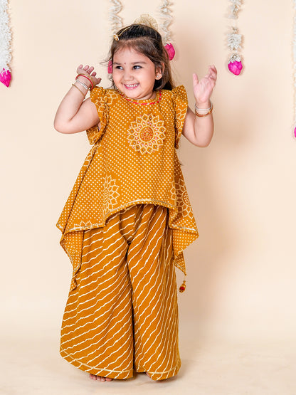 Child wearing a mustard yellow traditional outfit with floral patterns on a beige background