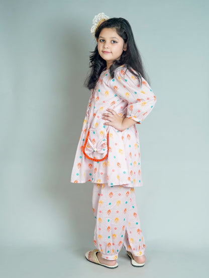 Young girl wearing a floral outfit with a plain background